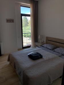 una camera da letto con un grande letto con una grande finestra di SaBa Apartments in Old Tbilisi a Tbilisi City