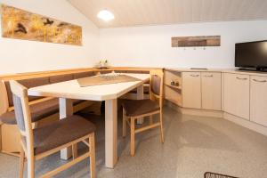 a kitchen with a table and chairs and a television at Haus Schöpf in Neustift im Stubaital