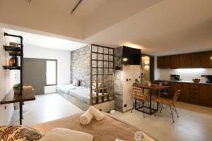 a living room with a bed and a kitchen at Orion Eco Suites in Karteros