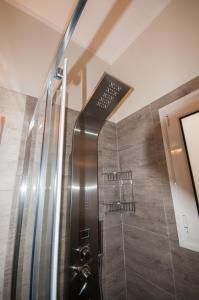 a shower with a glass door in a bathroom at Di fronte alla fortezza in Nafplio