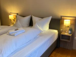 a hotel room with two beds with white pillows at Horchem Hotel-Restaurant-Café-Bar in Monschau +67 photos