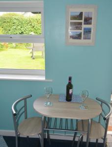 a table with two glasses and a bottle of wine at The Creamery in Liskeard +13 photos