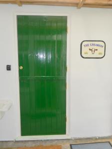 a green door with a we chamber sign on a wall at The Creamery in Liskeard