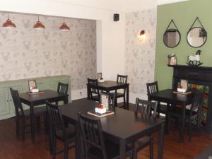 a dining room with tables and chairs in a restaurant at Powys Lodge in Scarborough