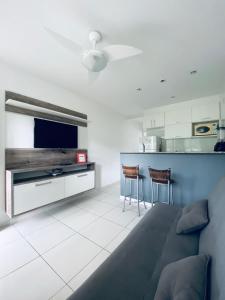 a living room with a couch and a tv at Eco Ribeira in Angra dos Reis