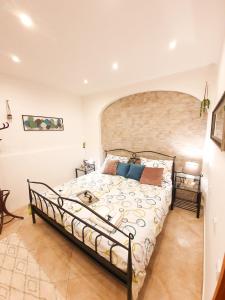 a bedroom with a bed with a brick wall at Apartament Colosseum view in Pula