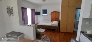 a small bedroom with a bed and a window at Apartments Mamic in Pula