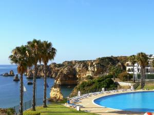 a swimming pool next to a body of water at WOW OCEAN VIEW, 150mts to Beach & 10 min to Centre in Lagos
