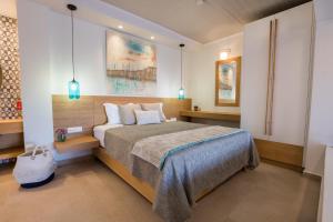 a bedroom with a large bed with two pillows at Two Goats Villas in Kyra Panagia