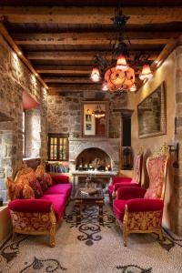 a living room with two couches and a fireplace at Nikos Takis Fashion Boutique Hotel in Rhodes Town