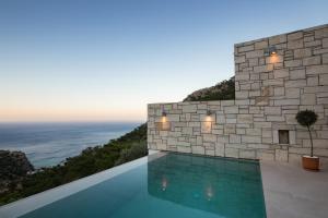 a house on the cliff with a swimming pool at Two Goats Villas in Kyra Panagia