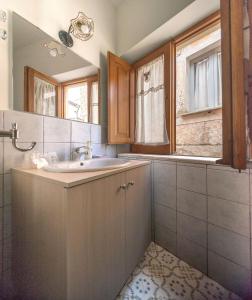 a bathroom with a sink and a mirror at La stanza dell'angolo in Maratea