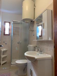 a bathroom with a toilet and a sink and a shower at Danijela in Mali Lošinj