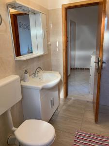 a bathroom with a white toilet and a sink at Danijela in Mali Lošinj