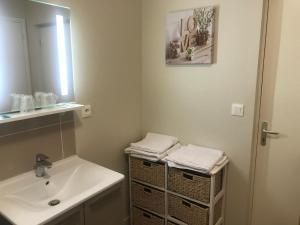 a bathroom with a sink and a mirror at La Villa Port Winston - Face Mer Chambres & Studios in Saint-Côme-de-Fresné +110 photos