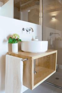 a bathroom with a white sink and a mirror at SUKHA loft at the Castle in Aljezur