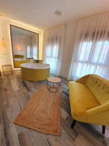 a living room with a yellow couch and a table at Reina Victoria Prado Sastre in Alicante