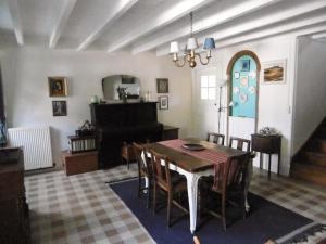 a dining room with a table and chairs at La Bicyclette Bleue in Montpinchon +35 photos