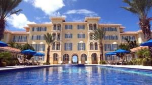 a large building with a swimming pool in front of it at Villa Renaissance Unit 205 Grace Bay Beach in Grace Bay
