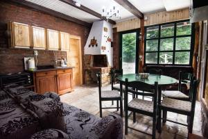 a kitchen with a table and chairs in a room at Vajat Tuk in Bajina Bašta