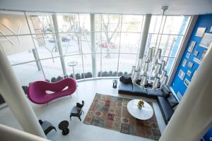 a living room with a purple chair and a table at Way Apartamentos in Montevideo