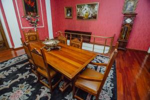 a dining room with a wooden table and chairs at Hotel Queen-Batumi in Batumi