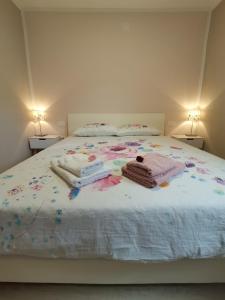 a bed with some blankets and pillows on it at Apartma VRTNICA in Bovec