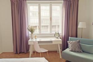 a room with a desk and a window with purple curtains at GORILLA - Central Station 100 meters away in Vienna