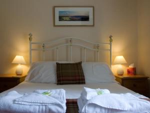 a bedroom with a bed with two towels on it at Horseshoe Hotel in Whitby