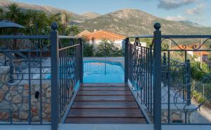 a staircase leading to a pool with mountains in the background at Levanta Unique Country Home in Dhavgáta
