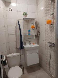 a small bathroom with a toilet and a sink at Sweet Home in Burgas City