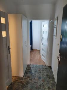 an empty room with a hallway with two doors at Apartament Aga in Ustrzyki Dolne