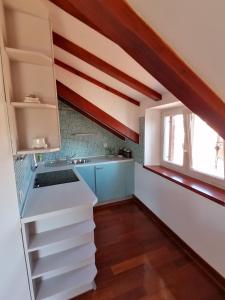 a kitchen with white cabinets and a window at Villa Sv. Petar in Trogir