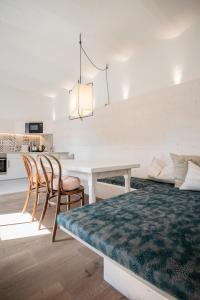 a kitchen and dining room with a table and chairs at Kesslerstadel in Matrei in Osttirol