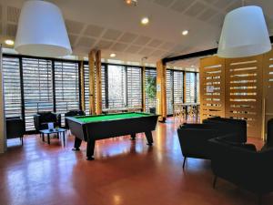 a billiard room with a pool table and chairs at Les Tentes Bivouacs by Le Marintan in Saint-Michel-de-Maurienne