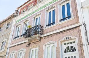 a large brick building with a balcony on it at Ambassador River Shower Suites in Lisbon