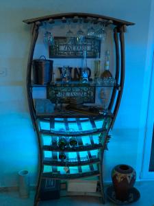 a wine rack in a room with blue lights at Apartments Vila Vino in Sveta Nedelja