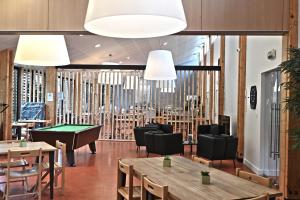 a restaurant with tables and a pool table at Les Tentes Bivouacs by Le Marintan in Saint-Michel-de-Maurienne
