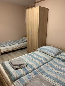A bed or beds in a room at Apartmánový dom Magda