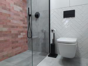 a bathroom with a shower and a white toilet at Apartament Old Town Nest in Gdańsk +39 photos