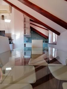 a glass table in a kitchen with white chairs at Villa Sv. Petar in Trogir