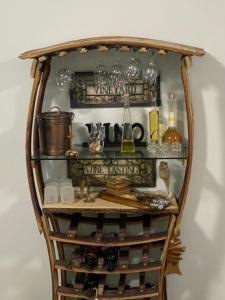 a shelf with wine glasses and other items on it at Apartments Vila Vino in Sveta Nedelja
