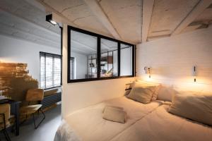 a bedroom with a large bed with a window at Bed & Breakfast Easy to Sleep in Lemmer +30 photos