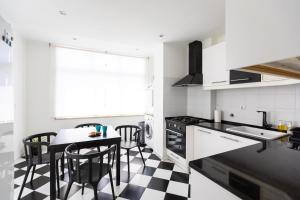 a kitchen with a black and white checkered floor at Ambassador River Shower Suites in Lisbon