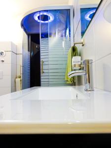 a bathroom with a white sink and a mirror at Krugs Haus Ferienwohnungen Wasserkuppe in Ebersburg