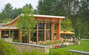 a house with a garden with tables and chairs at Topnotch Resort in Stowe