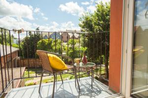 - un balcon avec une table et un oreiller jaune dans l'établissement Apartament u Violetty, à Łeba