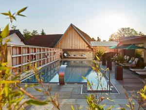 a swimming pool in a house with a wooden fence at Landhotel Krone in Heitersheim