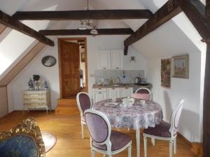 a dining room with a table and chairs at Zámeček Zdíky - Zámecký apartmán in Bujanov +31 photos