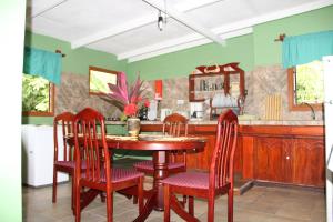 a dining room with a wooden table and chairs at Belle Des Iles in La Digue